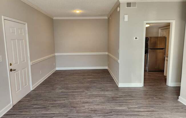 A room with a white door and a grey floor. The Cloisters Apartments, 902 67th Avenue North, Myrtle Beach, SC