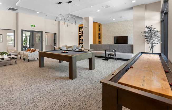 Game room with billiards and shuffleboard tables - The Venue at Orange