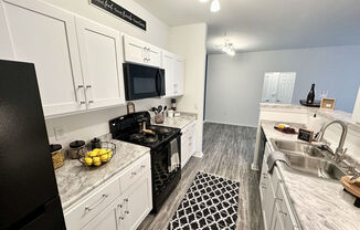A kitchen with black and white checkered floor mat.
