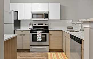 Renovated Kitchen with Quartz Countertops, Sleek Cabinets and Hardwood Floors at Patchen Oaks Apartments, Lexington, Kentucky 40517