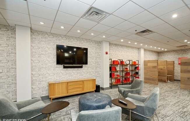 a room with chairs and a tv on the wall