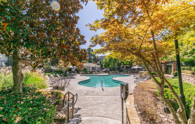 a swimming pool with trees and benches next to it at Deerfield Village, Alpharetta