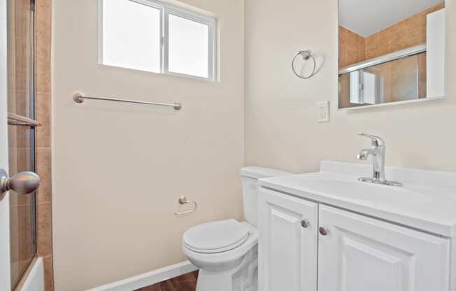 a bathroom with a toilet sink and shower