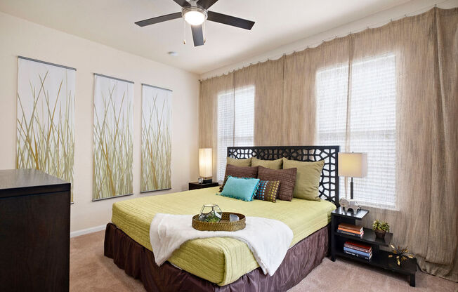 a bedroom with a bed and a ceiling fan