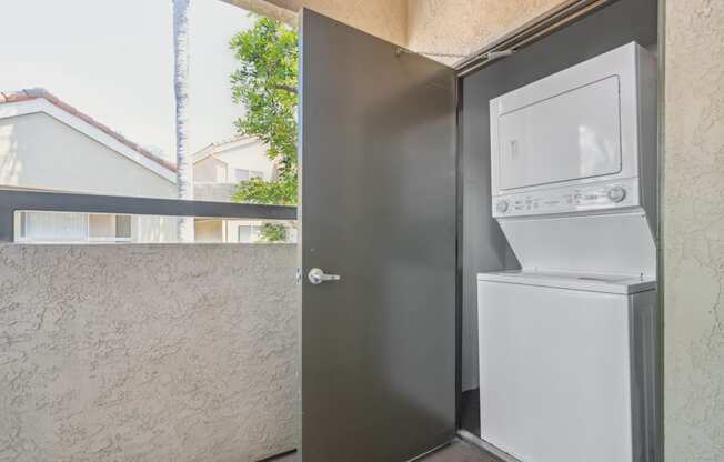 a washing machine and dryer on the side of a door