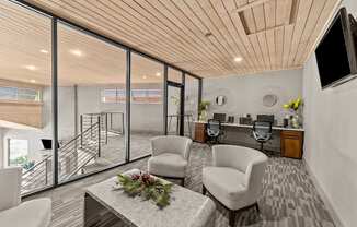 A modern living room with a wooden ceiling and a glass wall leading to a balcony.