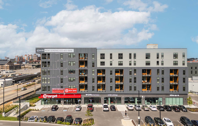 a large apartment building with cars parked in front of it