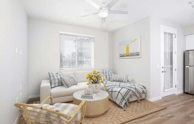A living room with a sofa, a coffee table, and a painting on the wall.