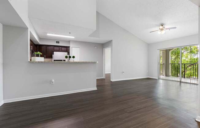 A spacious room with wooden floors and white walls.