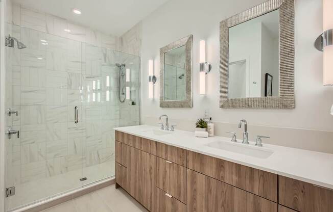 a bathroom with two sinks and a shower