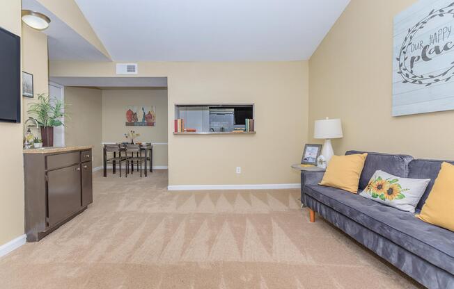 a living room filled with furniture and a flat screen tv