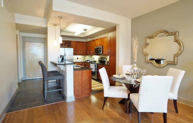 a dining room and kitchen with a table and chairs