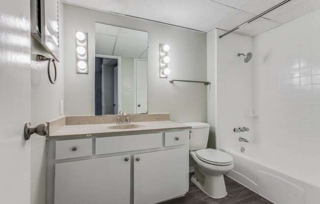 a bathroom with a sink toilet and a bath tub