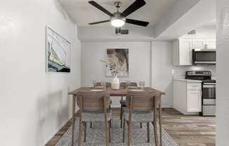our spacious kitchen and dining area with a ceiling fan and a dining table and chairs