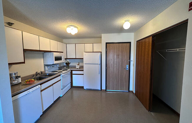 a kitchen with white appliances and white cabinets