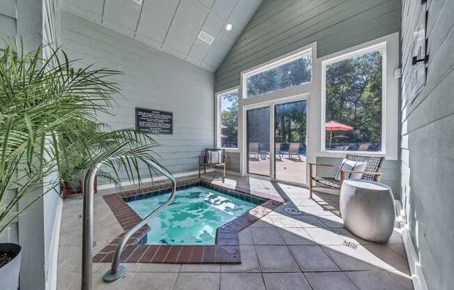 a small pool in the corner of a house with a sliding glass door