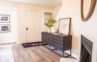 A room with a wooden floor and a white door.