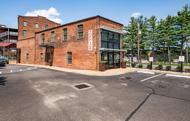 a red brick building with a sign on the side of a street