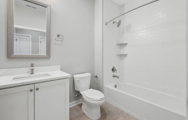 A white bathroom with a toilet, sink, and bathtub at Madison Prickett Preserve, Yardley