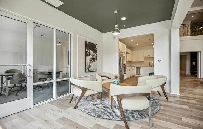 A modern dining room with a glass table and chairs.