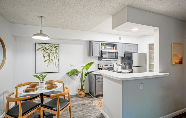 Set dining table and platinum kitchen interior at Treehouse in Albuquerque, New Mexico