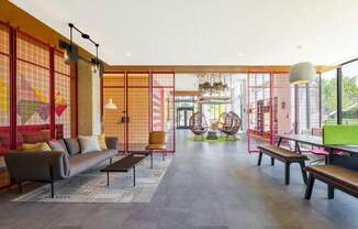 a living room with a couch and chairs and a ping pong table at The Chase at Bryant Street, Washington District of Columbia