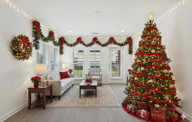 A Christmas tree is decorated with red and gold ornaments and is surrounded by wrapped gifts.