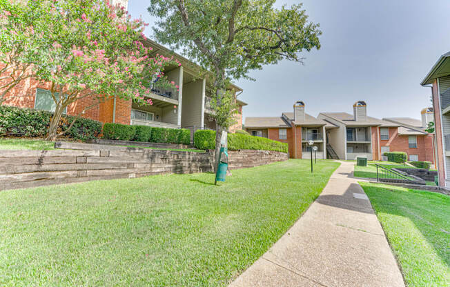 A residential area with apartment buildings and a well-maintained lawn at Copper Hill Apartments, Bedford