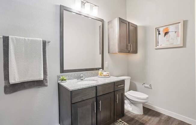 A bathroom with a white towel hanging on the wall.