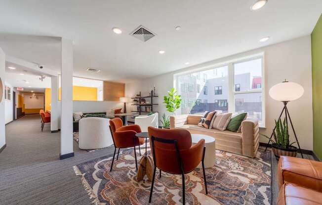 A living room with a grey carpet and a brown leather chair.