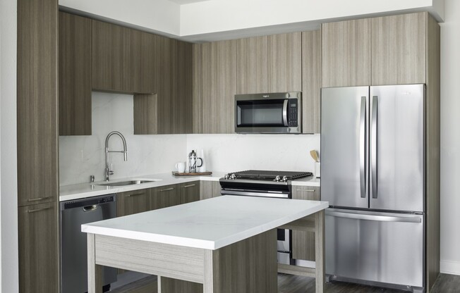 Gorgeous kitchen with stainless steel appliances, island and upscale grey finishes