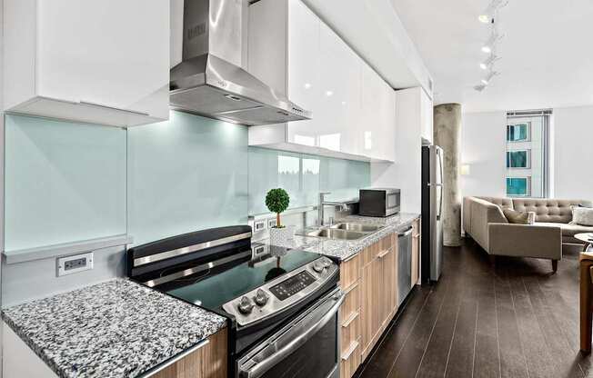 A modern kitchen with a black and white granite countertop.