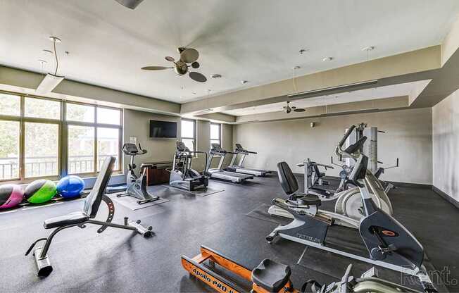A spacious home gym with a variety of exercise equipment.