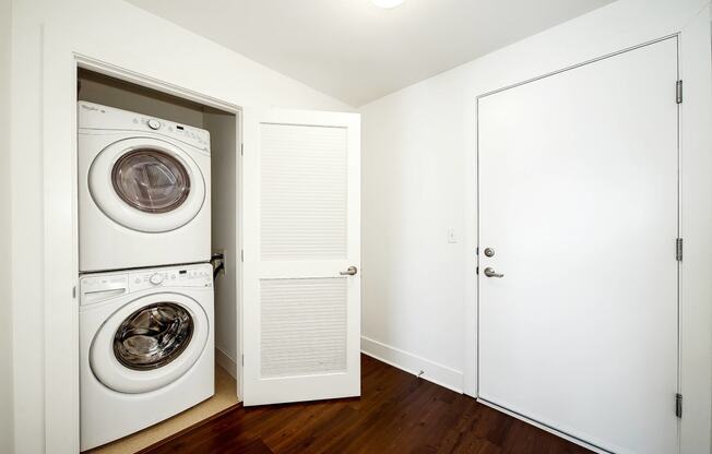 a white laundry room with a washer and dryer in it