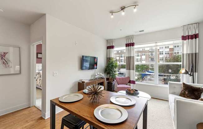 A dining room with a wooden table and chairs.