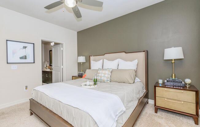 a bedroom with a bed and desk in a hotel room