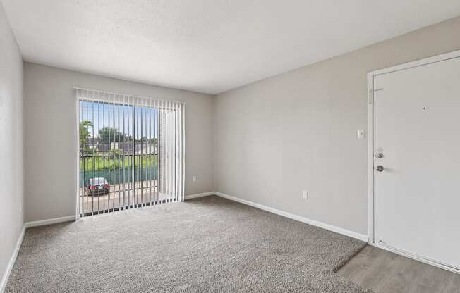 A room with a car parked outside the window.