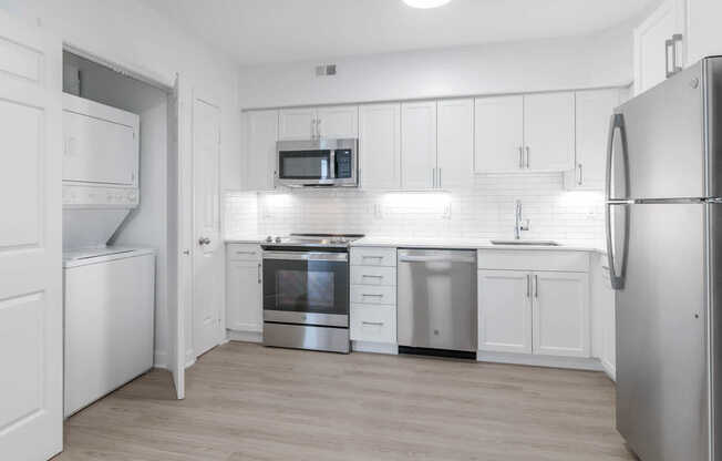 Kitchen with Stainless Steel Appliances and In-home Washer and Dryer