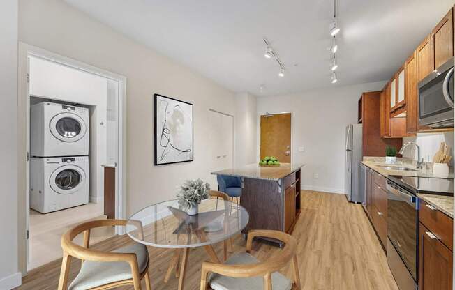 A modern kitchen with a glass table and chairs.