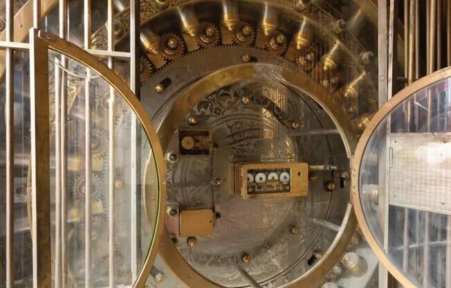 A large, circular, metallic object with a glass front and a small electronic device in the center.