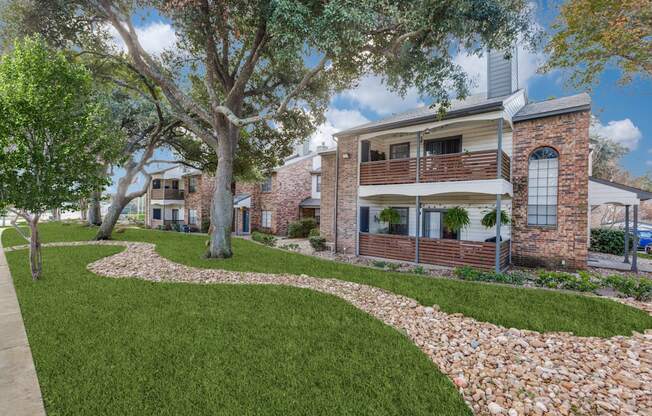 A house with a green lawn and a stone pathway in front.