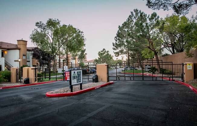 a parking lot in front of a building with a gate