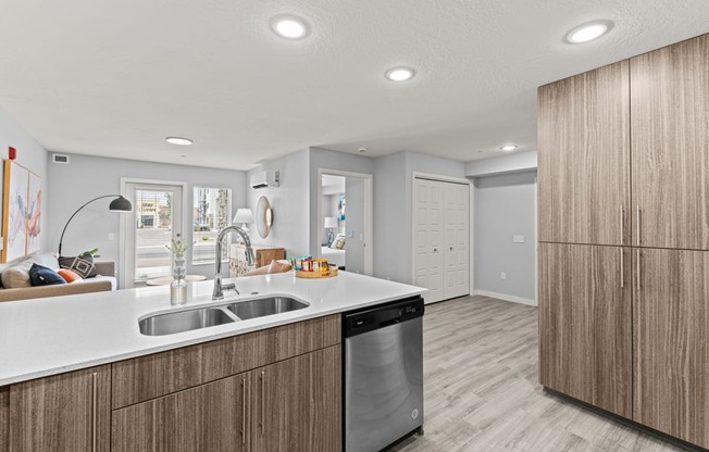 a kitchen with wooden cabinets and a stainless steel dishwasher