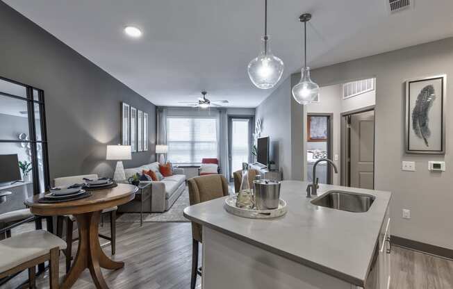 an open kitchen and living room with a couch and a table