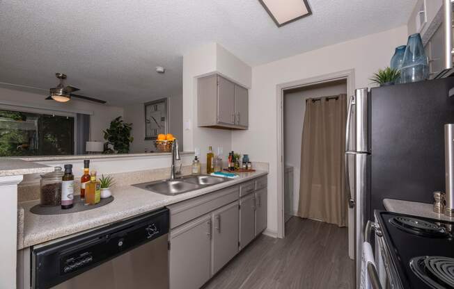 redesigned kitchen with stainless steel appliances and granite counter tops and a large window