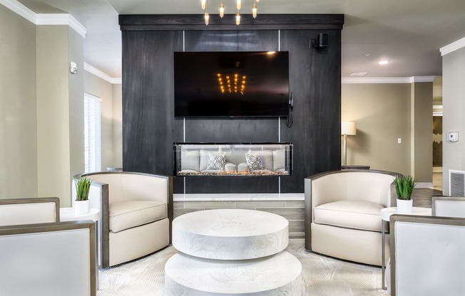 A modern living room with a large aquarium and a digital clock.