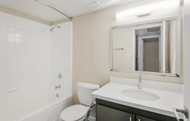 a bathroom with a sink toilet and a mirror