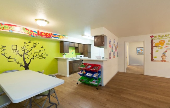 a dining room and kitchen with a table and a refrigerator