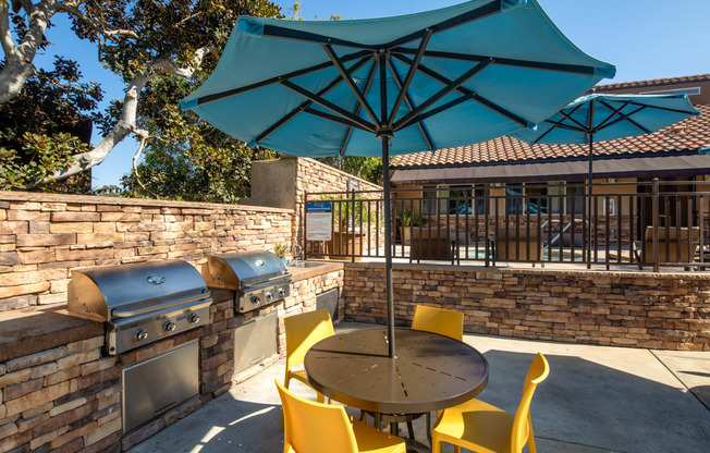 Patio with a table and chairs and an umbrella at Ascend2300, Carlsbad, CA, 92008