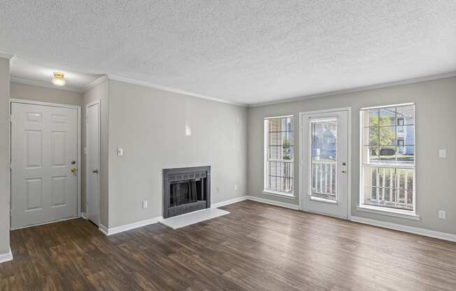 A room with a fireplace and sliding glass doors.